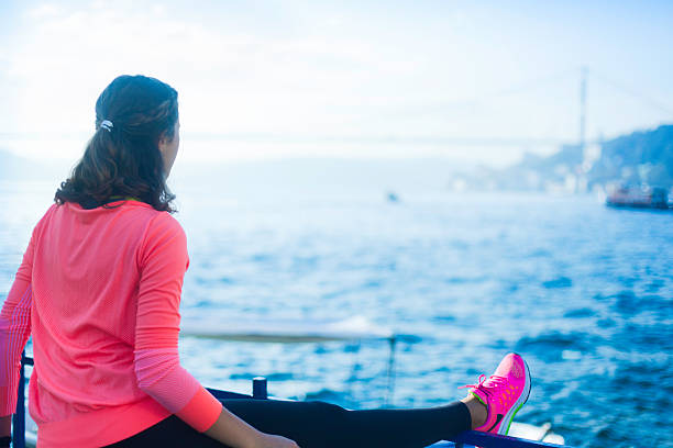More files of this series on port. One young woman exercising and stretching next to Bosphorus strait. Shot in Istanbul Turkey.  Made for the Istanbul 2014 istockalypse.
