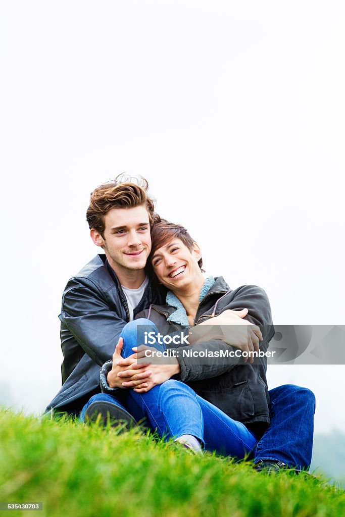 Young couple in love embracing in park Autumn Vertical Young couple in love embracing in Park. Autumn  clothing, vertical frame. Overcast sky. 20-29 Years Stock Photo