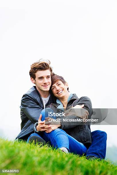 Young Couple In Love Embracing In Park Autumn Vertical Stock Photo - Download Image Now