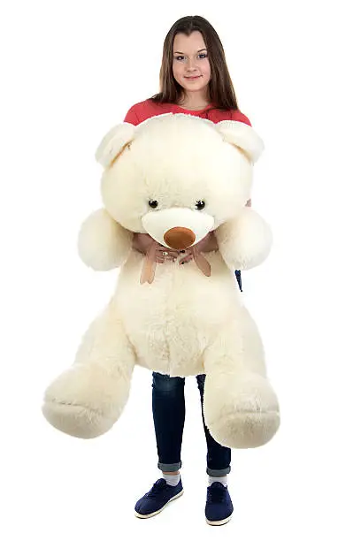 Photo of Teenage girl holding teddy bear in full lenght