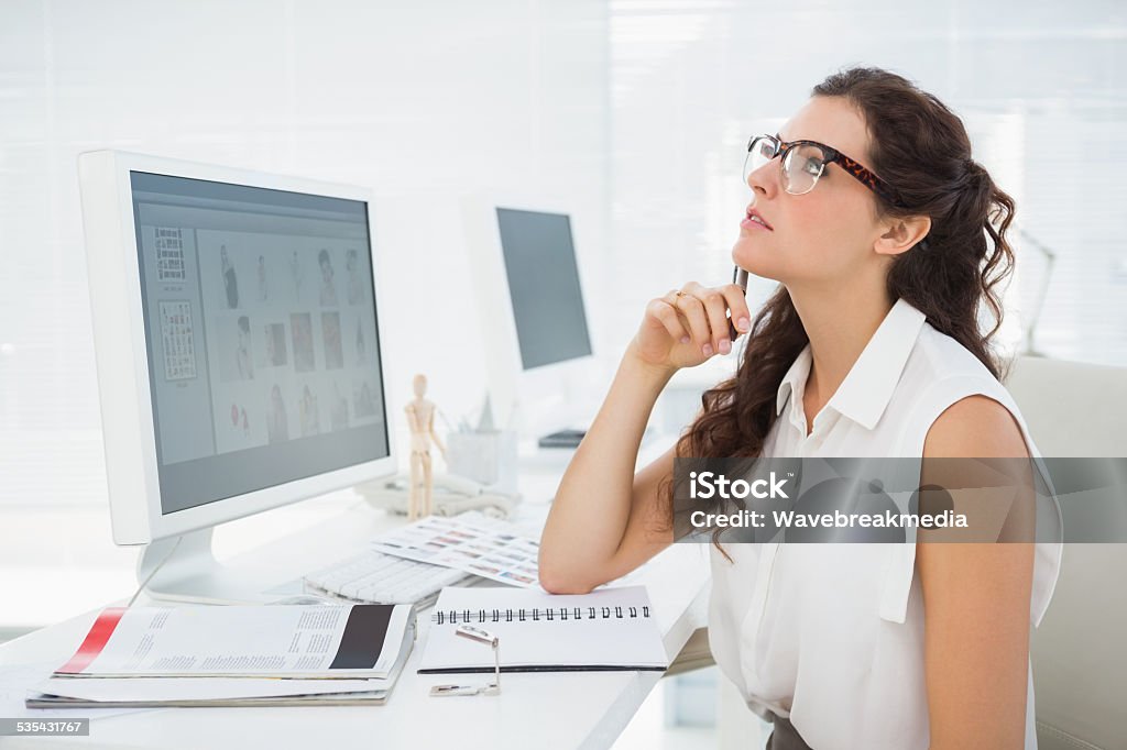 Serious businesswoman sitting and thinking Serious businesswoman sitting and thinking in the office 20-24 Years Stock Photo