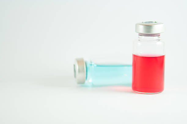 istock Red and blue liquid in injection vials 535431835