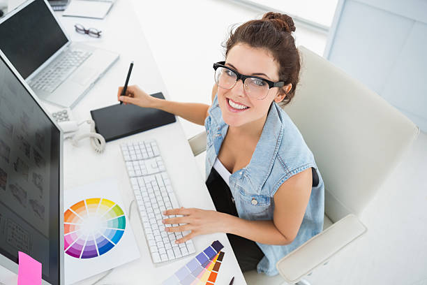 smiling designer using computer and digitizer - fotoredacteur stockfoto's en -beelden