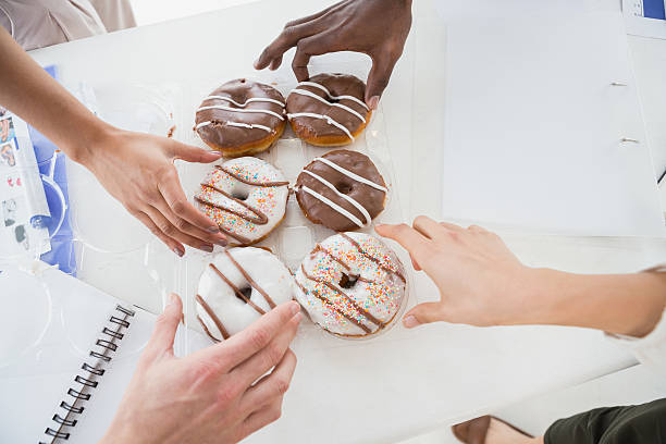 istock Business people taking doughnut at desk 535433017