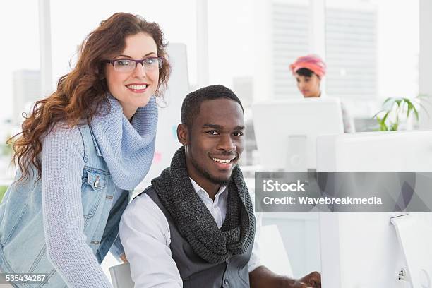 Smiling Coworkers Looking At Camera Together Stock Photo - Download Image Now - 20-24 Years, 20-29 Years, 2015