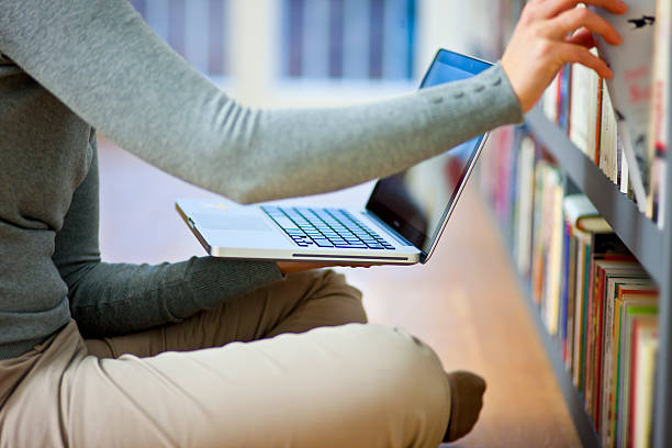 istock Young woman with laptop in home interior 535434607