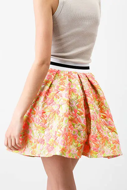 Photo of Woman in a short multicolor skirt