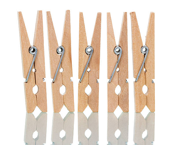 istock Wooden clothespins close-up isolated on white. 535444018