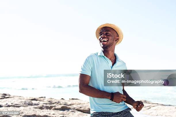Cheerful Young African Man Enjoying At The Beach Stock Photo - Download Image Now - Men, Beach, Summer