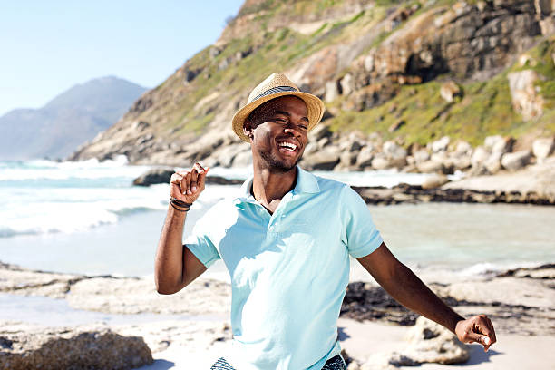 istock Young african man dancing at the beach 535445398