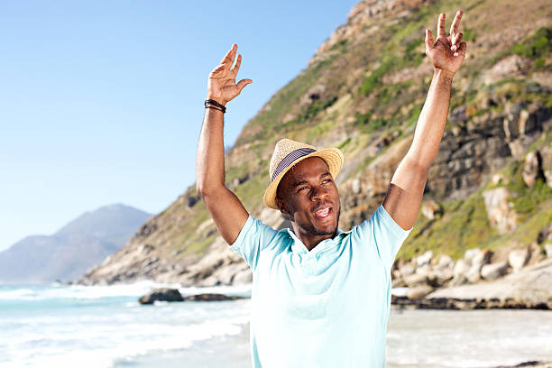 istock Stylish young guy with hat enjoying at the beach 535445814