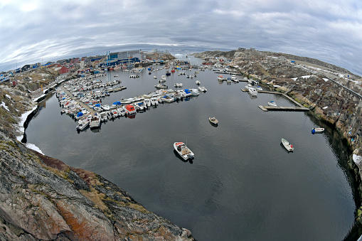Harbor in Ilulissat, Greenland. Fisheye view of harbor, ilulissat is a fishery town in Greenland. North pole of the world. People fishing and earning their lifes there.