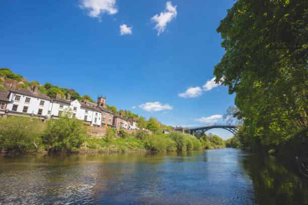 Ironbridge A stock photo of Iron bridge in Shropshire, England. It lies in the civil parish of The Gorge, in the borough of Telford and Wrekin. The famous Iron Bridge is a 100 ft cast iron bridge that was built across the river in 1779. Photographed with the Canon EOS 5DSR. ironbridge shropshire stock pictures, royalty-free photos & images