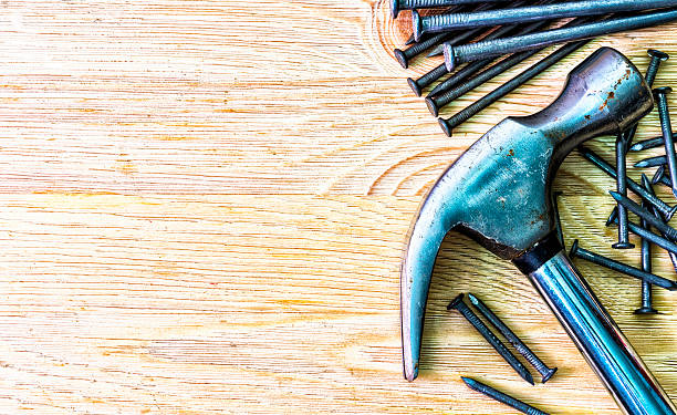 istock Hammer and nails on the wooden table. 535447236