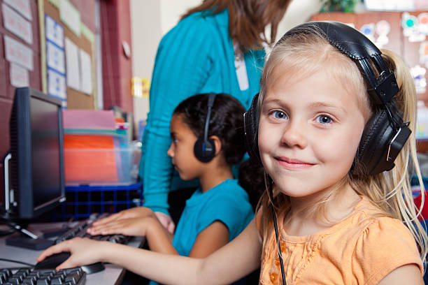 istock Cute little girl in school's computer lab 535448984