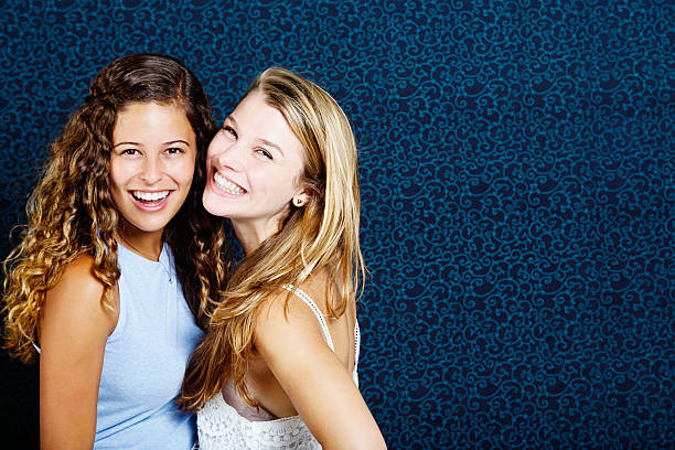istock Two beautiful young women smiling happily. Copy space on background. 535449797