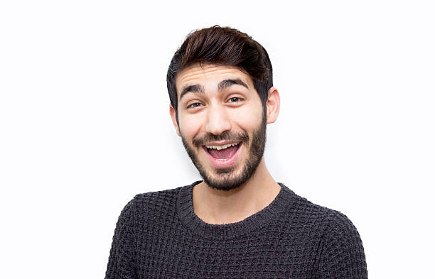 istock Portrait of surprised young man smiling on white background 535450378