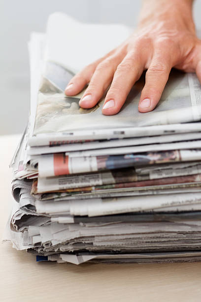 Reduce, reuse, recycle Shot of a hand on top of a stack of newspapershttp://195.154.178.81/DATA/istock_collage/0/shoots/781962.jpg newpapers stock pictures, royalty-free photos & images