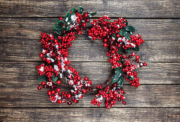 istock Holly christmas wreath on wooden table. 535451631