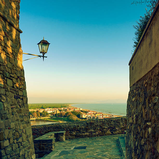Castiglione della Pescaia, lamp and terrace sunset view on the sea and beach. Maremma, Tuscany, Italy