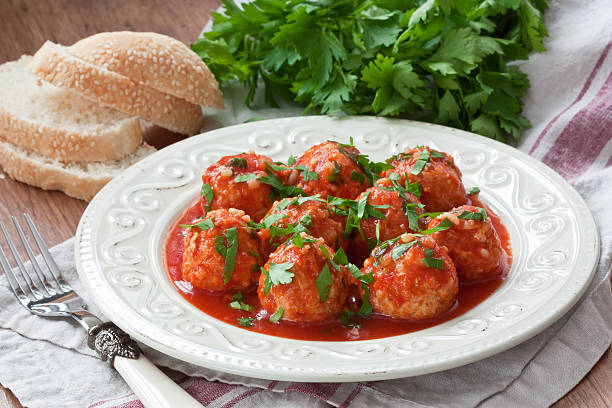 Meatballs with tomato sauce Delicious homemade chicken or turkey meatballs with rice, vegetable and tomato sauce stock fish stock pictures, royalty-free photos & images