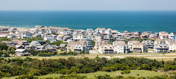 Buxton, NC. Crowed, overbuilt Outer Banks beach town Wall to wall beach house packed into the town of Buxton near Cape Hatteras in the Outer Banks of North Carolina. View from atop Cape Hatteras Lighthouse in Cape Hatteras National Seashore. Canon EOS 5Ds, 200 mm. cape hatteras stock pictures, royalty-free photos & images