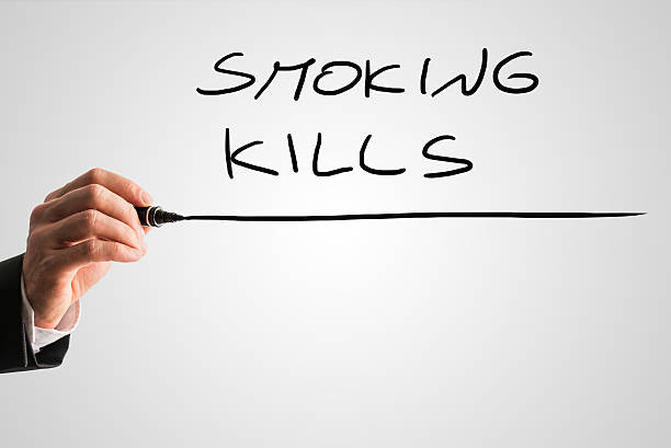istock Close up of the hand writing Smoking kills 535453679