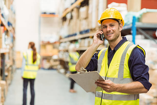 istock Warehouse worker talking on the phone holding clipboard 535454651