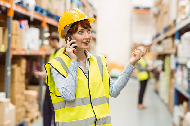 istock Warehouse manager talking on the phone looking around 535454773