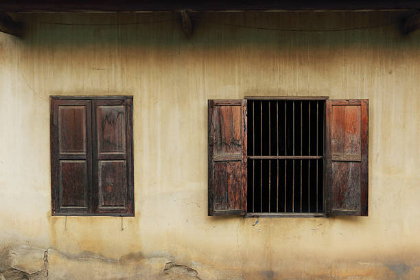 istock Old wooden windows open on a house wall 535454992