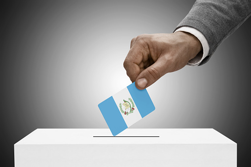 Black male holding flag. Voting concept - Guatemala