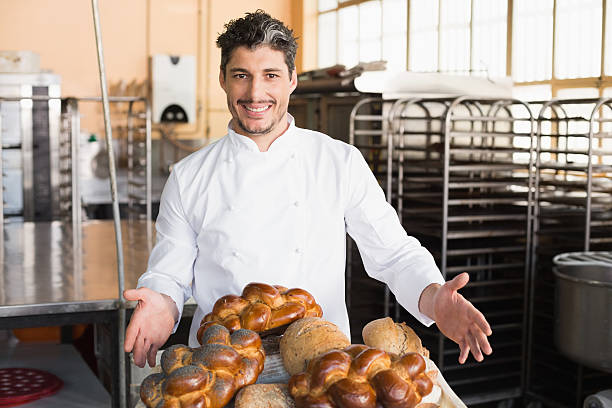 istock Smiling baker showing board of breads 535455861