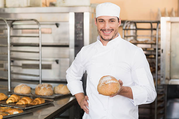 istock Baker holding a freshly baked loaf 535456593