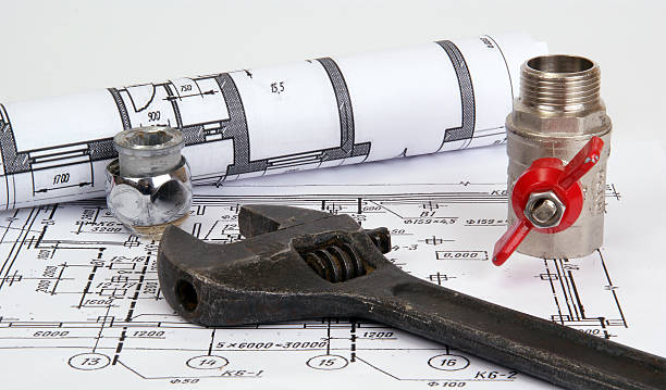 istock blueprint and plumbing supplies, closeup 535457245