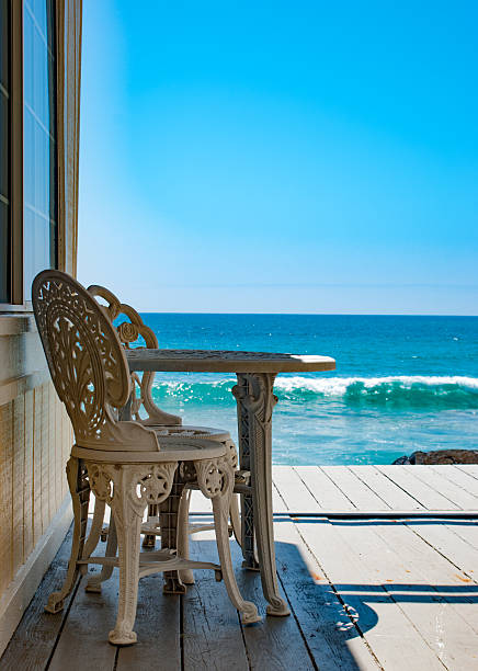 istock wrought Iron chairs on a porch overlooking the pacific ocean 535458484