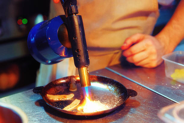 istock Chef is burning onion slices, toned, grain added 535460512