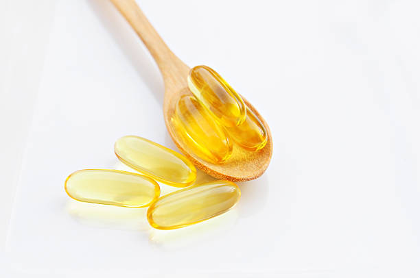 istock Cod liver oil in wooden spoon isolated ,White background 535463345