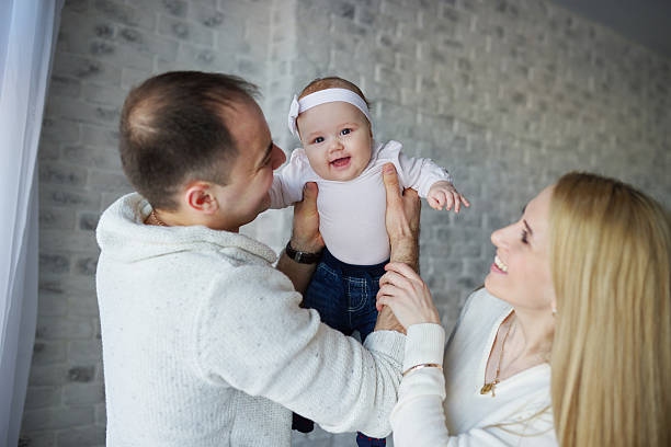 istock happy father and mother with baby 535463410