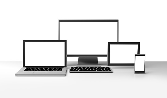 Desktop computer, laptop portable, smartphone and tablet with blank display on white background . Composition of computer technology communications and mobile devices on a desk with shadows and double clipping path on the background and white displays. Customizable screens. Computer generated image.