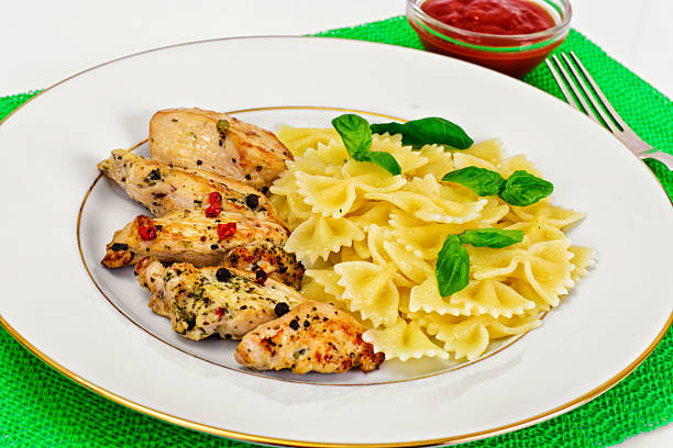 Grilled Chicken Fillet with Pasta Bows Studio Photo