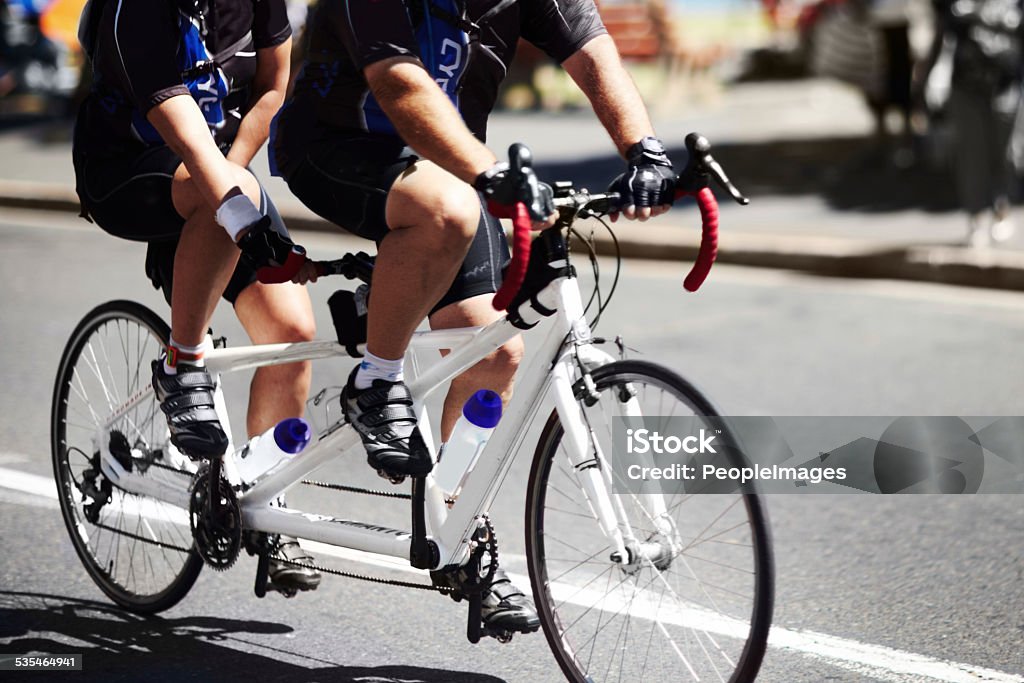 Two sets of legs are better than one! A cropped shot of two people riding a tandem bicyclehttp://195.154.178.81/DATA/istock_collage/0/shoots/781713.jpg Tandem Bicycle Stock Photo