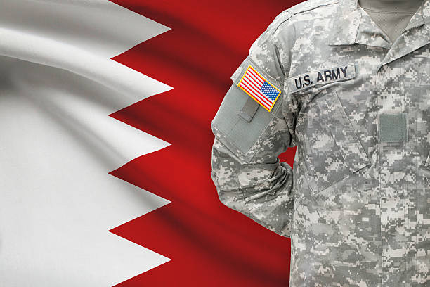 istock American soldier with flag on background - Bahrain 535465909