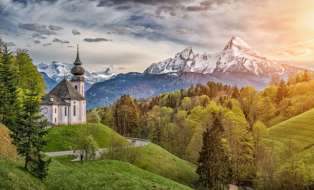 Idyllic mountain landscape in the Bavarian Alps, Berchtesgadener Land, Germany Beautiful mountain landscape in the Bavarian Alps with famous pilgrimage church of Maria Gern and Watzmann massif in golden evening light, Nationalpark Berchtesgadener Land, Bavaria, Germany bavarian alps photos stock pictures, royalty-free photos & images