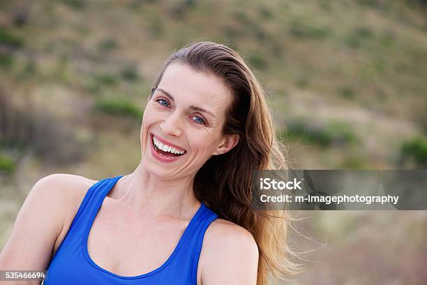 Older Woman Laughing Outside In Park Stock Photo - Download Image Now - 30-39 Years, Activity, Adult