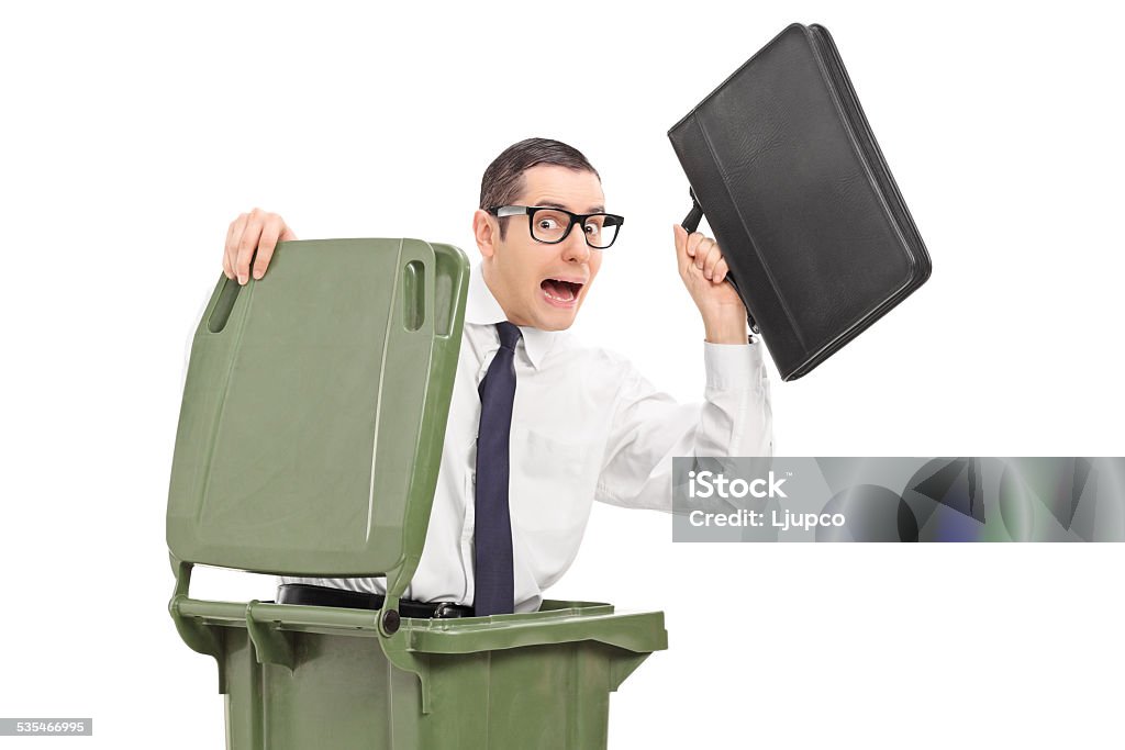 Terrified businessman hiding in a trash can Terrified businessman hiding in a trash can isolated against white background 20-29 Years Stock Photo