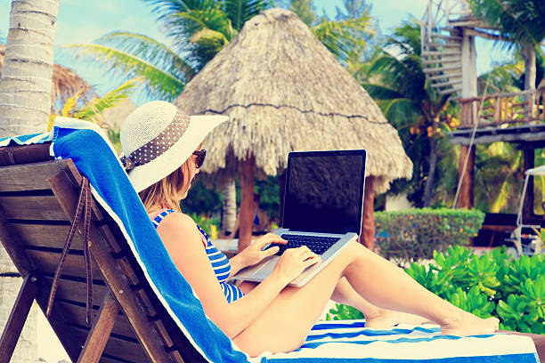 istock woman with laptop on tropical  vacation 535467427
