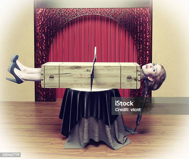 Magician Sawing A Woman Stock Photo - Download Image Now - Magician, Magic Trick, Women