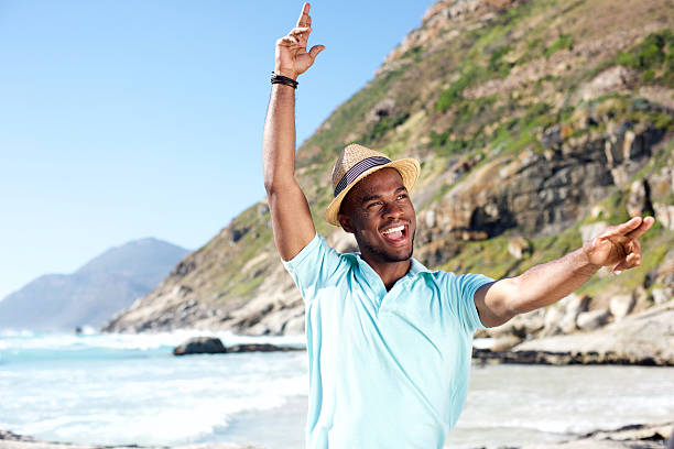 istock Attractive young african man having fun at the beach 535468232