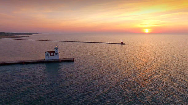 istock Stunning sunrise over illuminated lighthouse, Lake Michigan 535469378