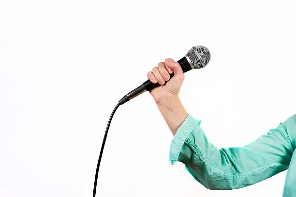 Photo of female hand with microphone